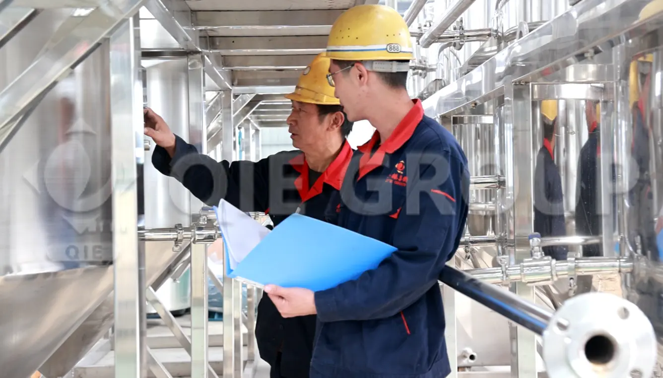 Engineer inspecting edible oil processing equipment on site